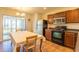 Eat-in kitchen featuring sleek appliances, dark cabinetry, and a sliding glass door to the outside at 3629 Brittlebank Dr, Raleigh, NC 27610