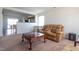 Comfortable living room with a tan leather sofa and adjacent view into the kitchen area at 3629 Brittlebank Dr, Raleigh, NC 27610