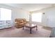 Bright living room with a cozy leather sofa, a coffee table, and plenty of natural light at 3629 Brittlebank Dr, Raleigh, NC 27610
