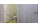 Compact toilet room with green mat and freshly painted walls at 3629 Brittlebank Dr, Raleigh, NC 27610