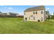 Expansive backyard featuring a gentle slope, well-maintained lawn, and a cozy patio with outdoor seating near the house at 3832 Stovall Dr, Haw River, NC 27258