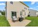 Exterior view of a home's backyard with an outdoor seating area and vinyl siding at 3832 Stovall Dr, Haw River, NC 27258