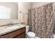 A bathroom featuring a vanity with granite countertops and a shower/tub combo with a patterned shower curtain at 3832 Stovall Dr, Haw River, NC 27258