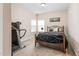 A bedroom with a metal frame bed, neutral-colored walls, and a treadmill at 3832 Stovall Dr, Haw River, NC 27258