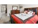 Comfortable bedroom with carpet floors, dresser, mirror, and picture frames on the wall at 3832 Stovall Dr, Haw River, NC 27258