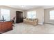 A bonus room featuring neutral carpet, a small sofa, a work desk, and a large cabinet at 3832 Stovall Dr, Haw River, NC 27258