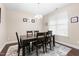 Elegant dining room with a dark wood table, rug, chandelier, and natural light at 3832 Stovall Dr, Haw River, NC 27258