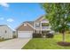 Charming two-story home with a two car garage, balcony, and manicured lawn at 3832 Stovall Dr, Haw River, NC 27258