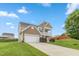 Two story home featuring a two car garage, balcony, and a long driveway at 3832 Stovall Dr, Haw River, NC 27258