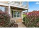Inviting front porch with decorative bushes and a charming dinosaur statue at 3832 Stovall Dr, Haw River, NC 27258