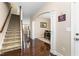 Hallway with hardwood floors and staircase leading to the upper level at 3832 Stovall Dr, Haw River, NC 27258
