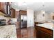 A kitchen featuring dark cabinets, stainless steel appliances, granite countertops, and hardwood floors at 3832 Stovall Dr, Haw River, NC 27258
