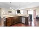 A kitchen featuring dark cabinets, stainless steel appliances, granite countertops, and hardwood floors at 3832 Stovall Dr, Haw River, NC 27258