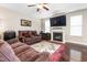 Cozy living room featuring a fireplace, dark wood floors, and a comfortable sofa at 3832 Stovall Dr, Haw River, NC 27258