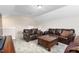 Bonus room with a dark wood coffee table, two brown couches, and carpet floors at 3832 Stovall Dr, Haw River, NC 27258