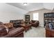 Bonus room with a dark wood coffee table, two brown couches, and built in bookshelves at 3832 Stovall Dr, Haw River, NC 27258