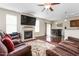 A living room with hardwood floors, a fireplace, a ceiling fan, and an entertainment bar with seating at 3832 Stovall Dr, Haw River, NC 27258