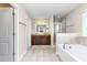 Bright main bathroom features a double vanity, soaking tub, tiled shower, and separate water closet at 3832 Stovall Dr, Haw River, NC 27258