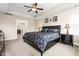 Inviting main bedroom features a tray ceiling, a ceiling fan, and an ensuite bathroom at 3832 Stovall Dr, Haw River, NC 27258