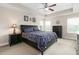 Inviting main bedroom features a tray ceiling, a ceiling fan, and a coordinated bedroom set at 3832 Stovall Dr, Haw River, NC 27258