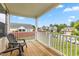Relaxing covered porch showcasing outdoor seating with views of the manicured yard and charming neighborhood at 3832 Stovall Dr, Haw River, NC 27258