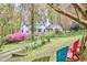 Home exterior with Adirondack chairs in the backyard perfect for relaxing under trees at 4 The Gln, Chapel Hill, NC 27514