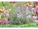 Charming home exterior showcases lush landscaping and flowering shrubs in a serene setting at 4 The Gln, Chapel Hill, NC 27514