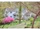 Charming white house with a covered front porch, surrounded by lush landscaping and flowering trees at 4 The Gln, Chapel Hill, NC 27514