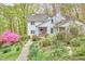 Lovely white house with covered front porch, beautifully landscaped yard, and a stone pathway leading to the entrance at 4 The Gln, Chapel Hill, NC 27514