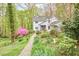 Beautiful two-story home with stone pathway through a lush, landscaped front yard at 4 The Gln, Chapel Hill, NC 27514