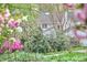 Charming home exterior showcases lush landscaping and flowering shrubs in a serene setting at 4 The Gln, Chapel Hill, NC 27514