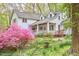 Beautiful home featuring a covered porch and mature trees in a lush landscape at 4 The Gln, Chapel Hill, NC 27514
