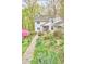 Beautiful two-story home with stone pathway through a lush, landscaped front yard at 4 The Gln, Chapel Hill, NC 27514