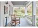 Inviting covered porch with rocking chair overlooking lush garden path at 4 The Gln, Chapel Hill, NC 27514