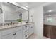 Bright bathroom featuring double vanity, granite counters, and a large framed mirror at 433 Triumph Ln, Wake Forest, NC 27587