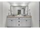 Bright bathroom featuring double vanity, granite counters, and a large framed mirror at 433 Triumph Ln, Wake Forest, NC 27587