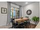 Dining room features a wood table, black chairs and a sliding glass door that brings in natural light at 433 Triumph Ln, Wake Forest, NC 27587
