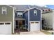 Exterior view of a two-story home with a white garage door and screened-in porch at 433 Triumph Ln, Wake Forest, NC 27587