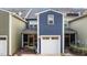 Exterior view of a two-story home with a white garage door and screened-in porch at 433 Triumph Ln, Wake Forest, NC 27587