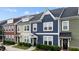 View of colorful townhomes with well-maintained lawns and landscaping at 433 Triumph Ln, Wake Forest, NC 27587