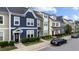 Street view of colorful townhomes with well-manicured lawns and landscaping at 433 Triumph Ln, Wake Forest, NC 27587