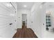 Hallway with wood floors and multiple doors, including access to bathroom and living areas at 433 Triumph Ln, Wake Forest, NC 27587