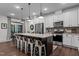 Bright kitchen features granite countertops, stainless steel appliances, and a large center island with seating at 433 Triumph Ln, Wake Forest, NC 27587
