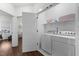 Laundry room with white washer and dryer, shelf storage, and door to the rest of the home at 433 Triumph Ln, Wake Forest, NC 27587