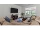 Comfortable living room with large sofa, window, and TV at 433 Triumph Ln, Wake Forest, NC 27587
