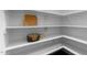 Walk-in pantry featuring ample white shelving with storage for dishware and kitchen accessories at 433 Triumph Ln, Wake Forest, NC 27587
