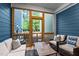 Screened-in porch with a dark blue accent wall, a coffee table, and comfortable seating at 433 Triumph Ln, Wake Forest, NC 27587