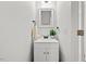 Powder room features a single sink vanity with a modern faucet and a decorative mirror at 480 Whitt Ave, Burlington, NC 27215