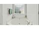 Bright bathroom features a soaking tub, tiled walls, and a glass block window at 480 Whitt Ave, Burlington, NC 27215