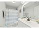 Updated bathroom with a new vanity, modern fixtures, and a shower with a blue and white curtain at 480 Whitt Ave, Burlington, NC 27215